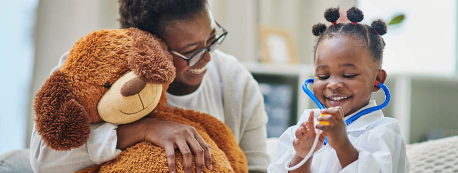little girl and doctor playing with a stethoscope