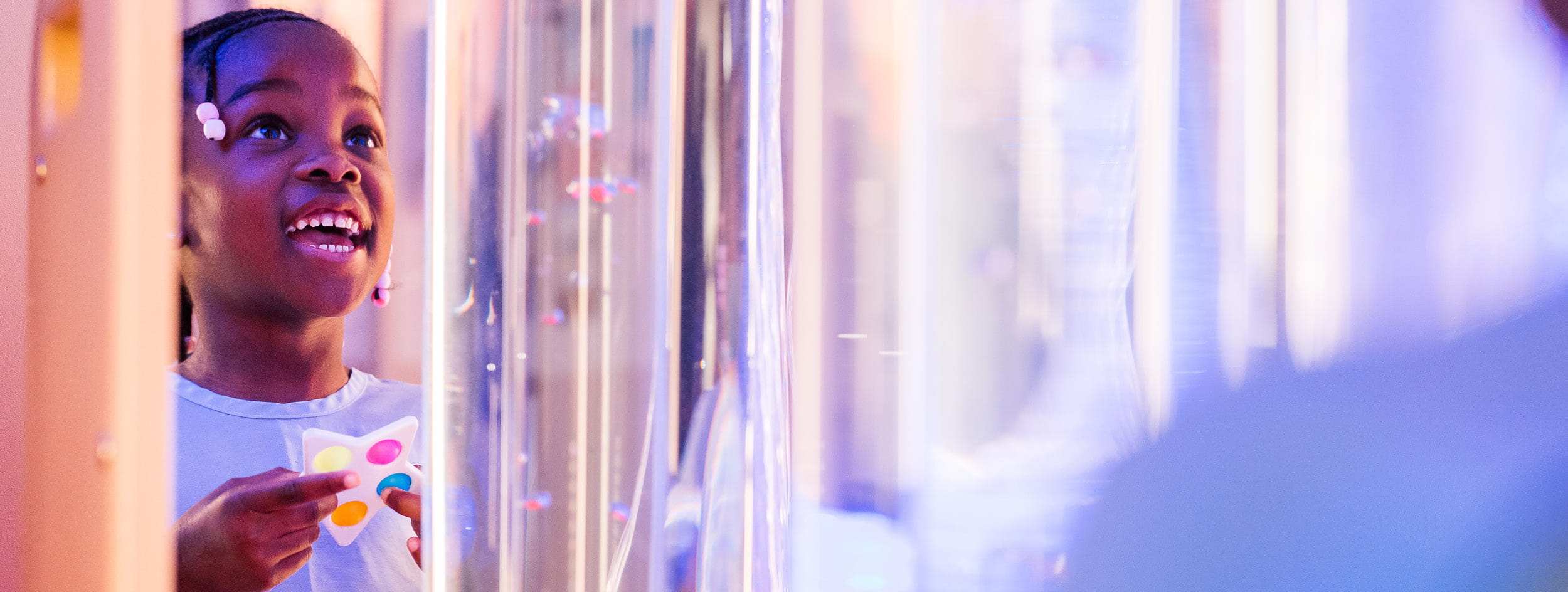 Young girl plays with sensory toy.