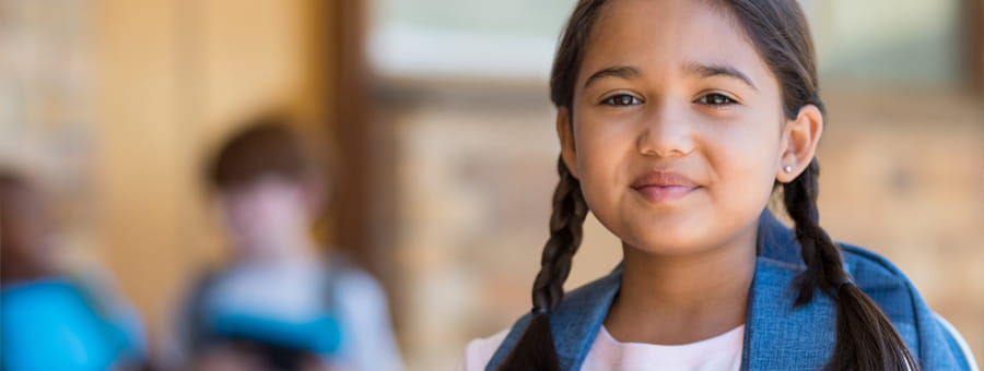 Happy young girl at school.