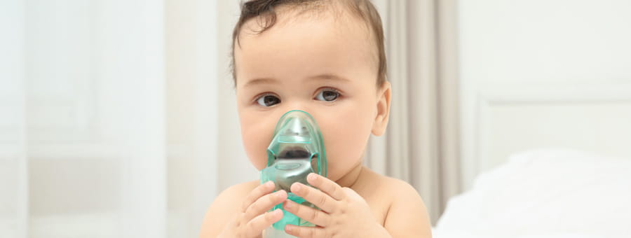 A baby uses a nebulizer.