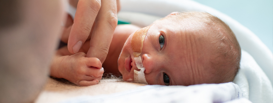 Baby and father in NICU.