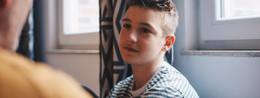 Teen and father talking.