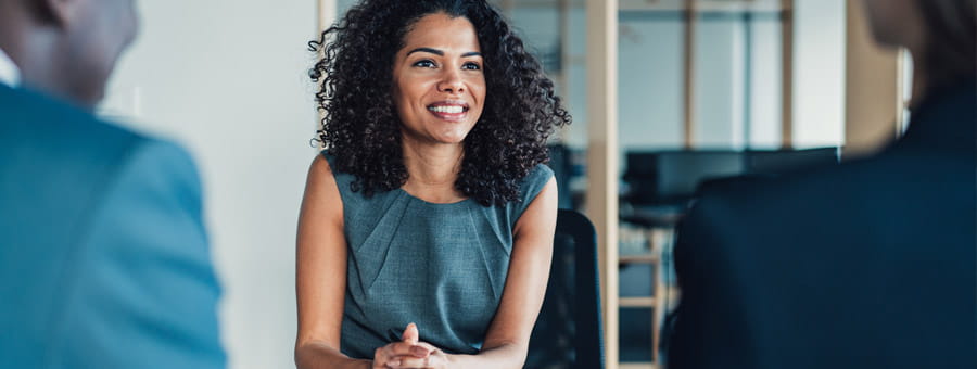 Coworkers talking in a business meeting.