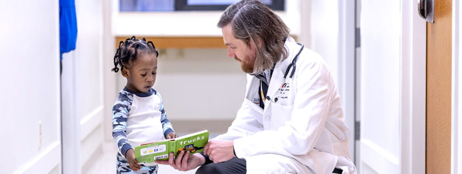 Dr. Yaun reads with a patient.