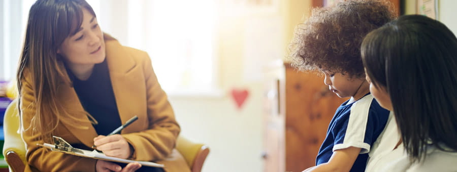 A boy is seen by a clinician at home.