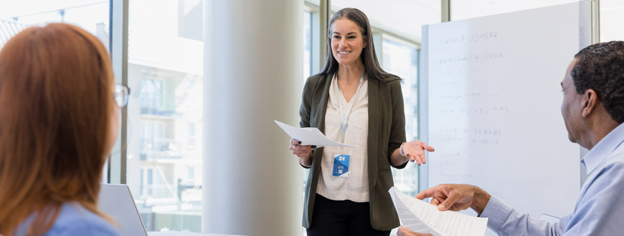 Hospital administrator talking in a meeting.