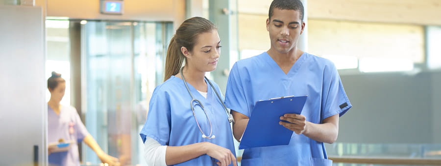 Nurse tech speaking with nursing mentor.