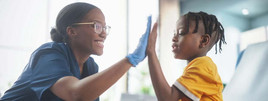 Child patient and doctor high five.