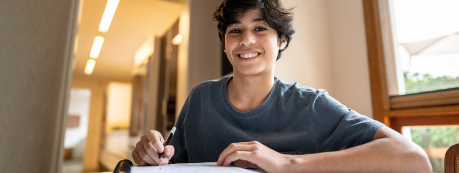 Content teenage boy studying.