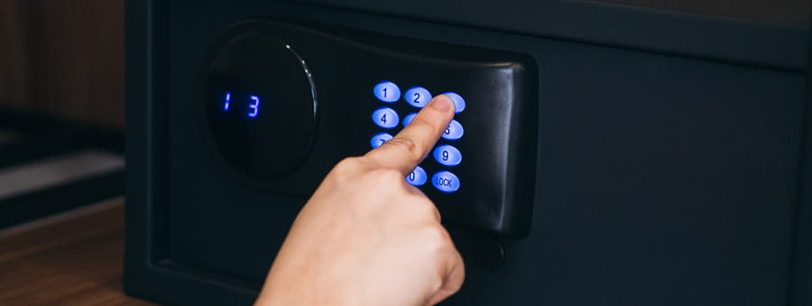 Hand entering code on a gun safe.