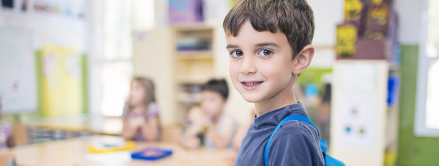 Young boy in elementary school classroom.