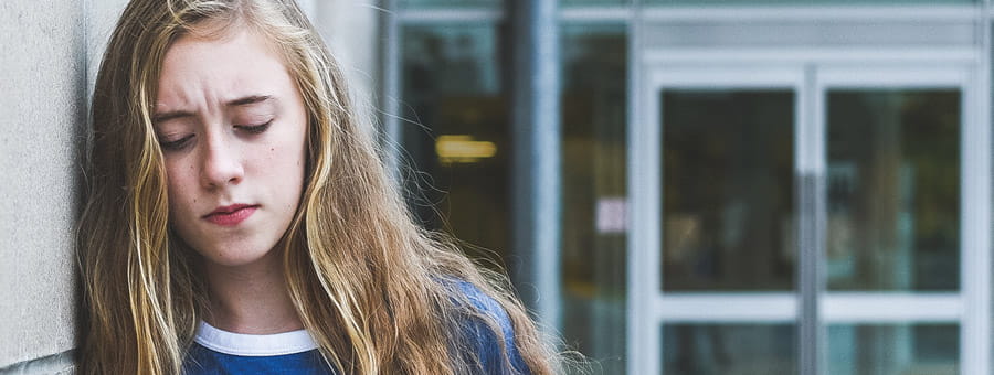 Upset teen outside of hospital.