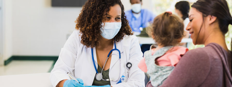 Doctor with mother and toddler.