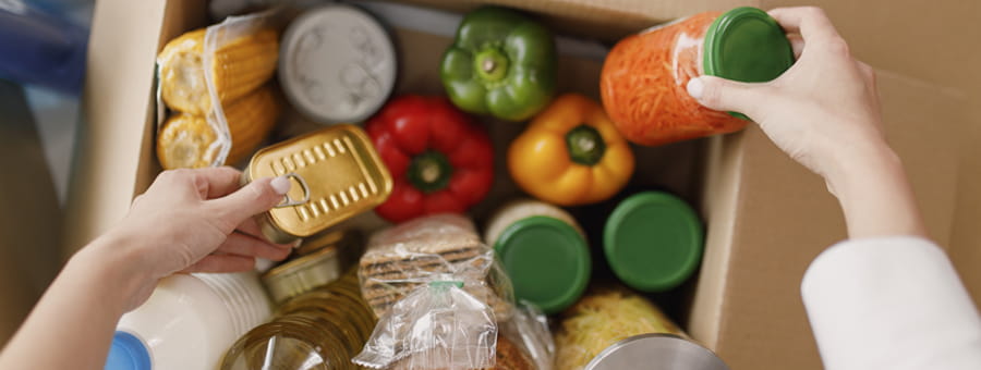 Packing a box with food.