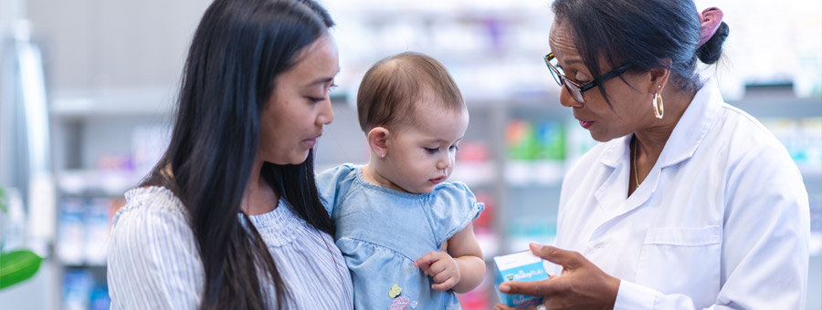 A mother with infant consults a pharmacist.