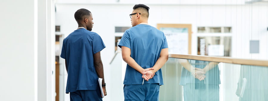 Nurse preceptor and mentee discussing a patient.