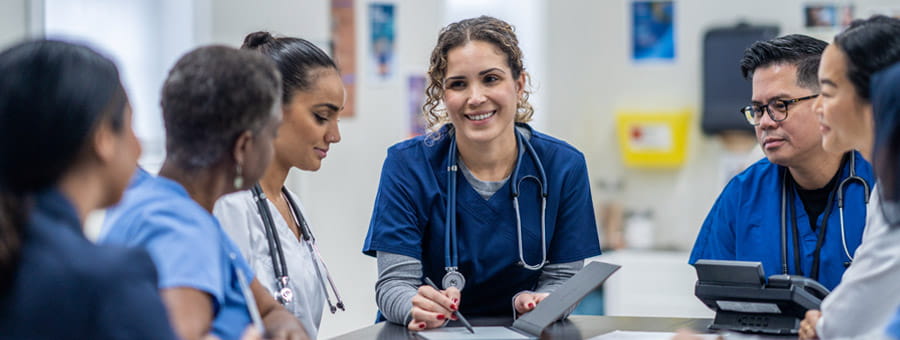 Group of clinical staff discusses patients.