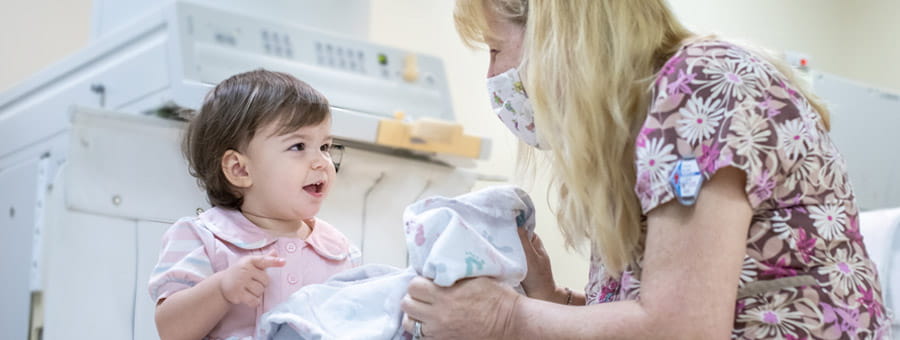 Young patient smiles at nurse.