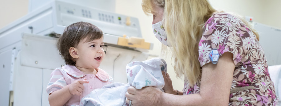 Young patient smiles at nurse.