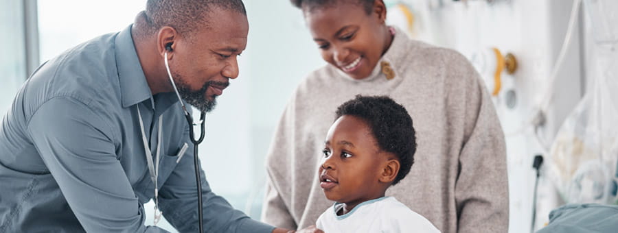 Doctor examines child patient in hospital.