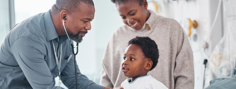 Doctor examines child patient in hospital.