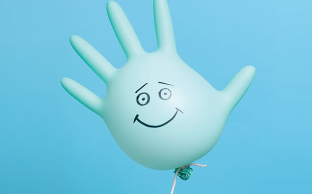 Surgical glove balloon with happy face drawn on it.