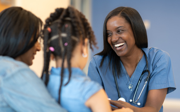 Nurse talks with patient and parent.
