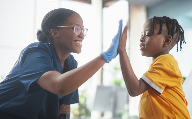 Child patient and doctor high five.