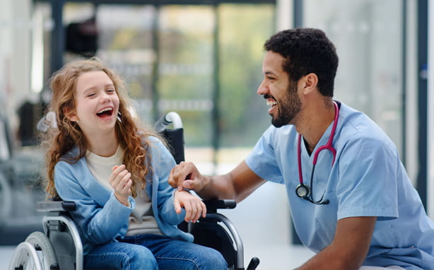 Happy child patient and nurse laughing.