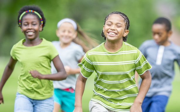 Happy kids running a race.