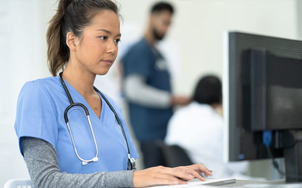 Nurse looking at a computer monitor.