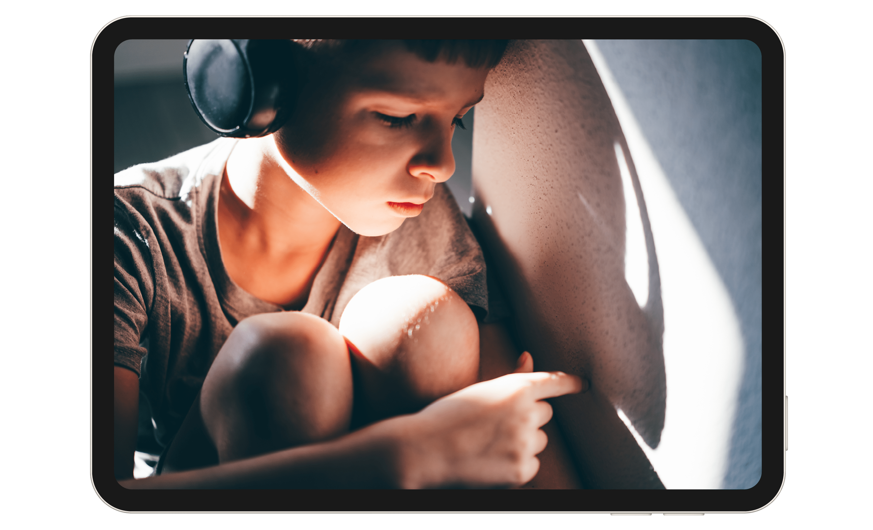 Child sitting in a car with headphones on.
