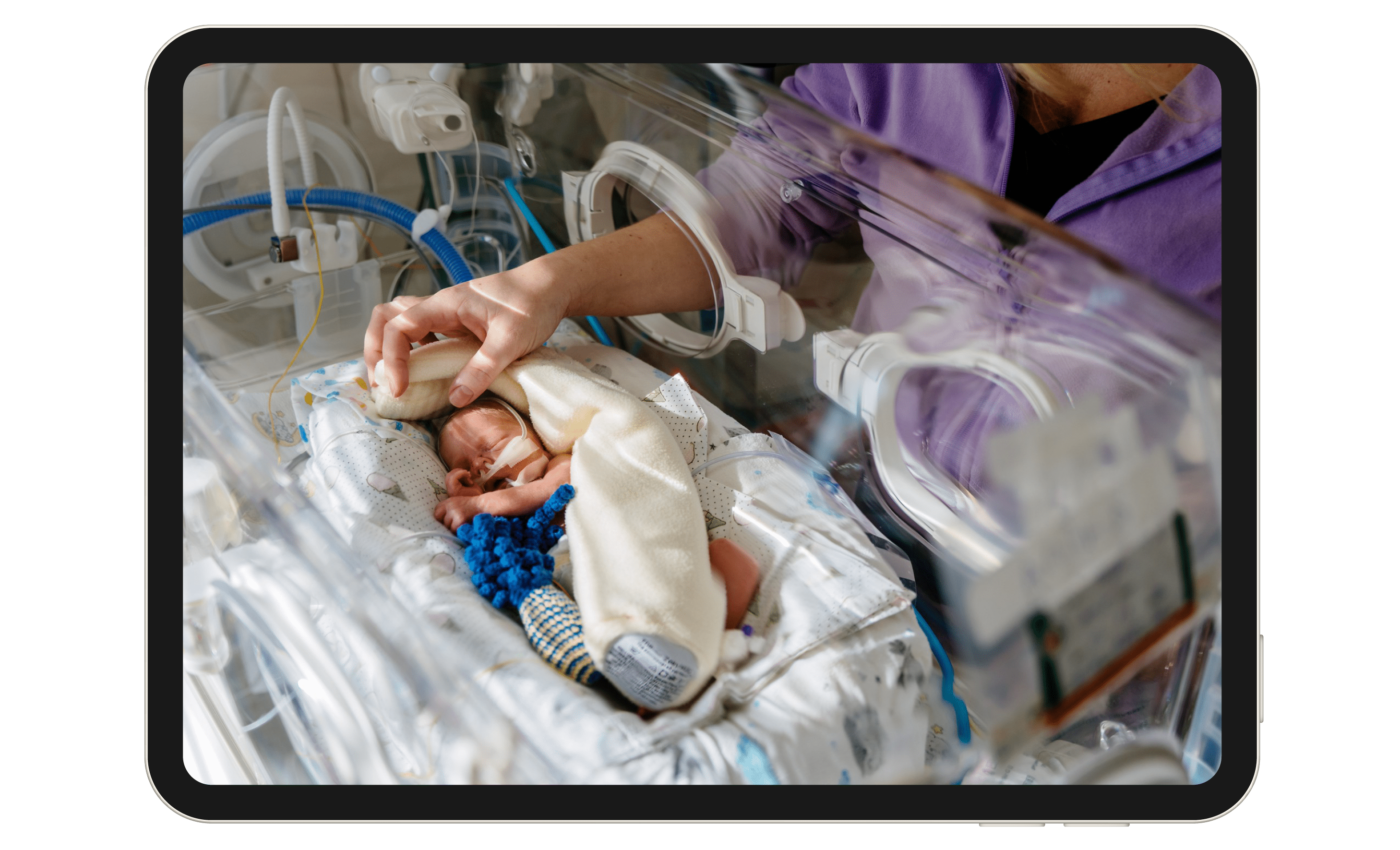 Nurse cares for baby in hospital nursery.