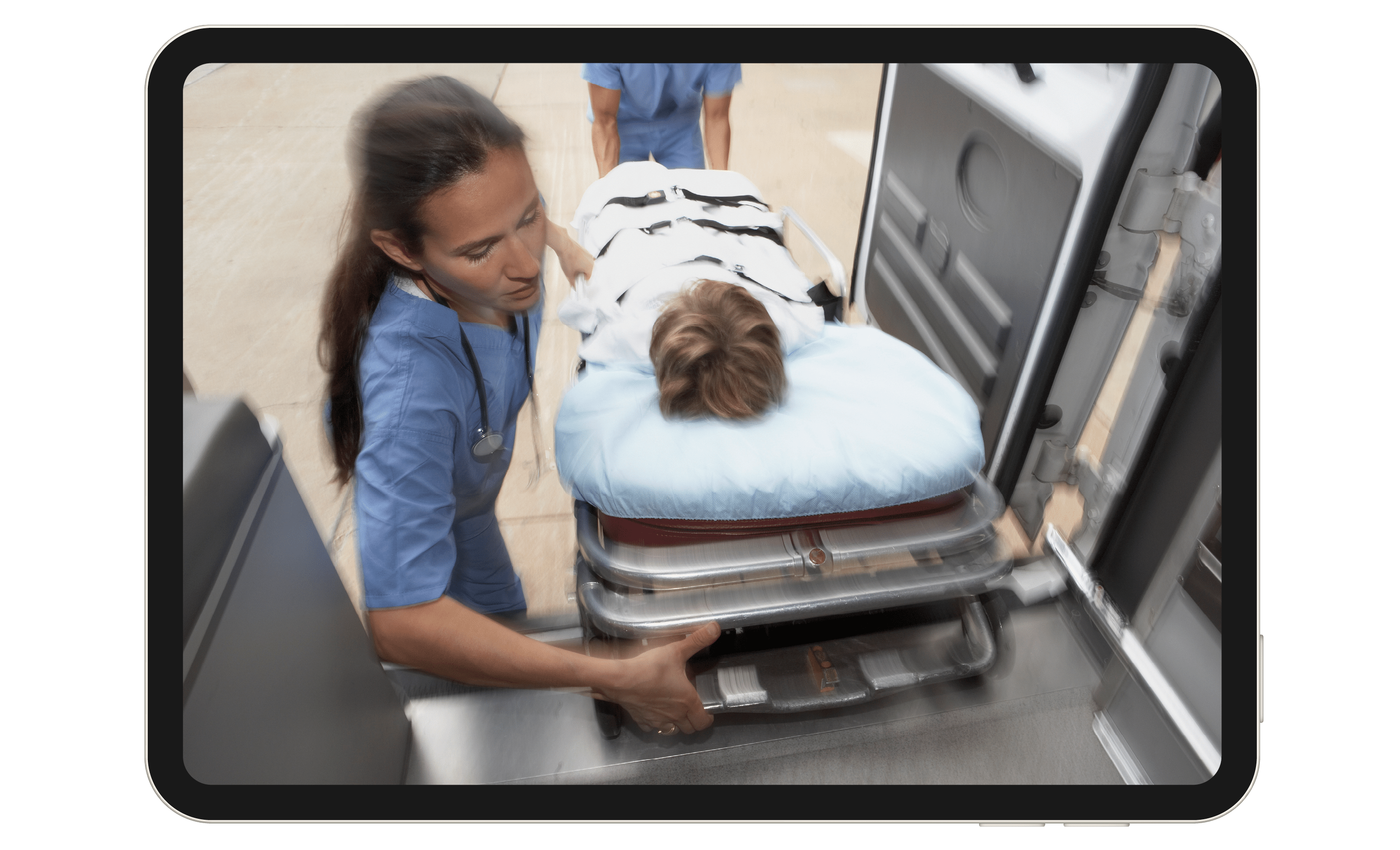 An EMT loads a child on a gurney into an ambulance.