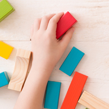child hands with building blocks