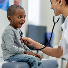 Happy child is examined by pediatrician.