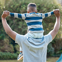 Boy on father's shoulders.