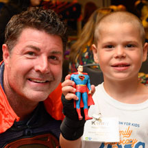 Boy posing with Superman at FAD celebration