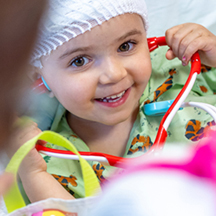 Girl listening to stethoscope. Photo by Chris Van Kat, Children's National Hospital