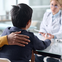 Child talking with health care professional.