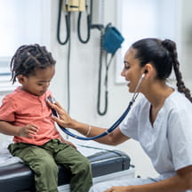 Doctor listens to patient's heart.