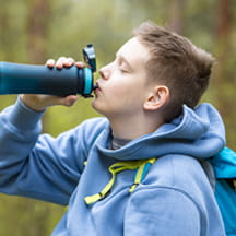 Boy drinking out of a water bottle.