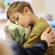 Mom comforts little boy.