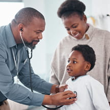 Doctor examines child patient in hospital.