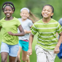 Happy kids running a race.
